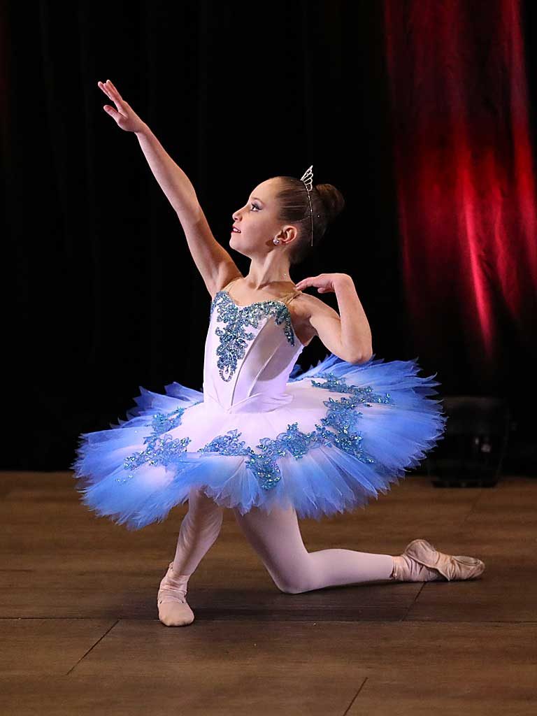 Dance student in purple tutu performing her routine